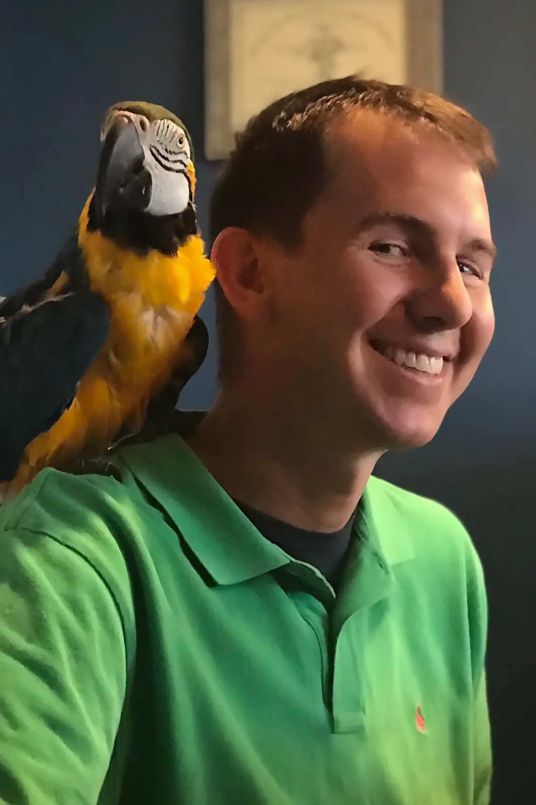 Dr. Walker with Charlie the parrot on his shoulder.