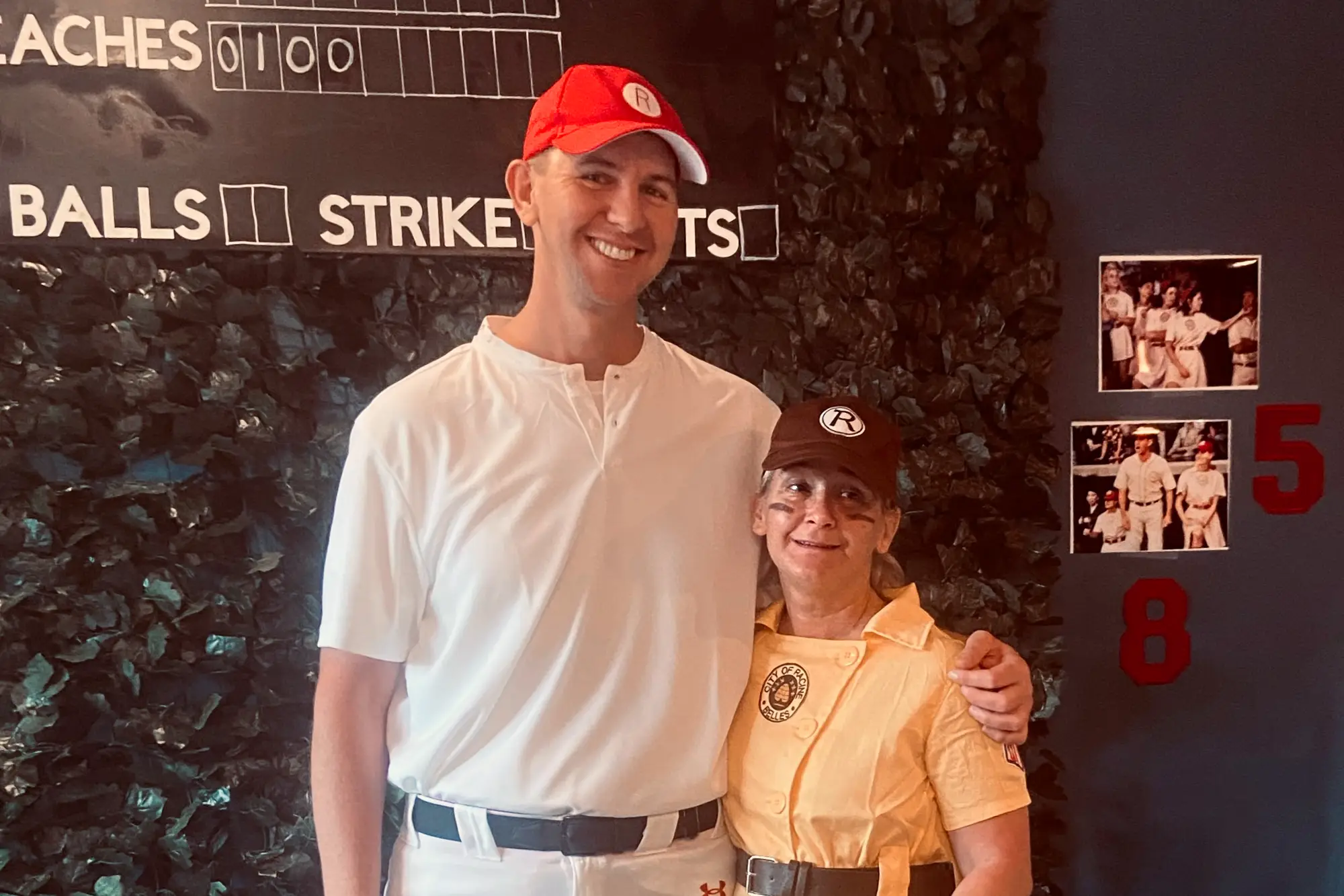 Dr Walker and staff member posing in League of Their Own Halloween costumes.