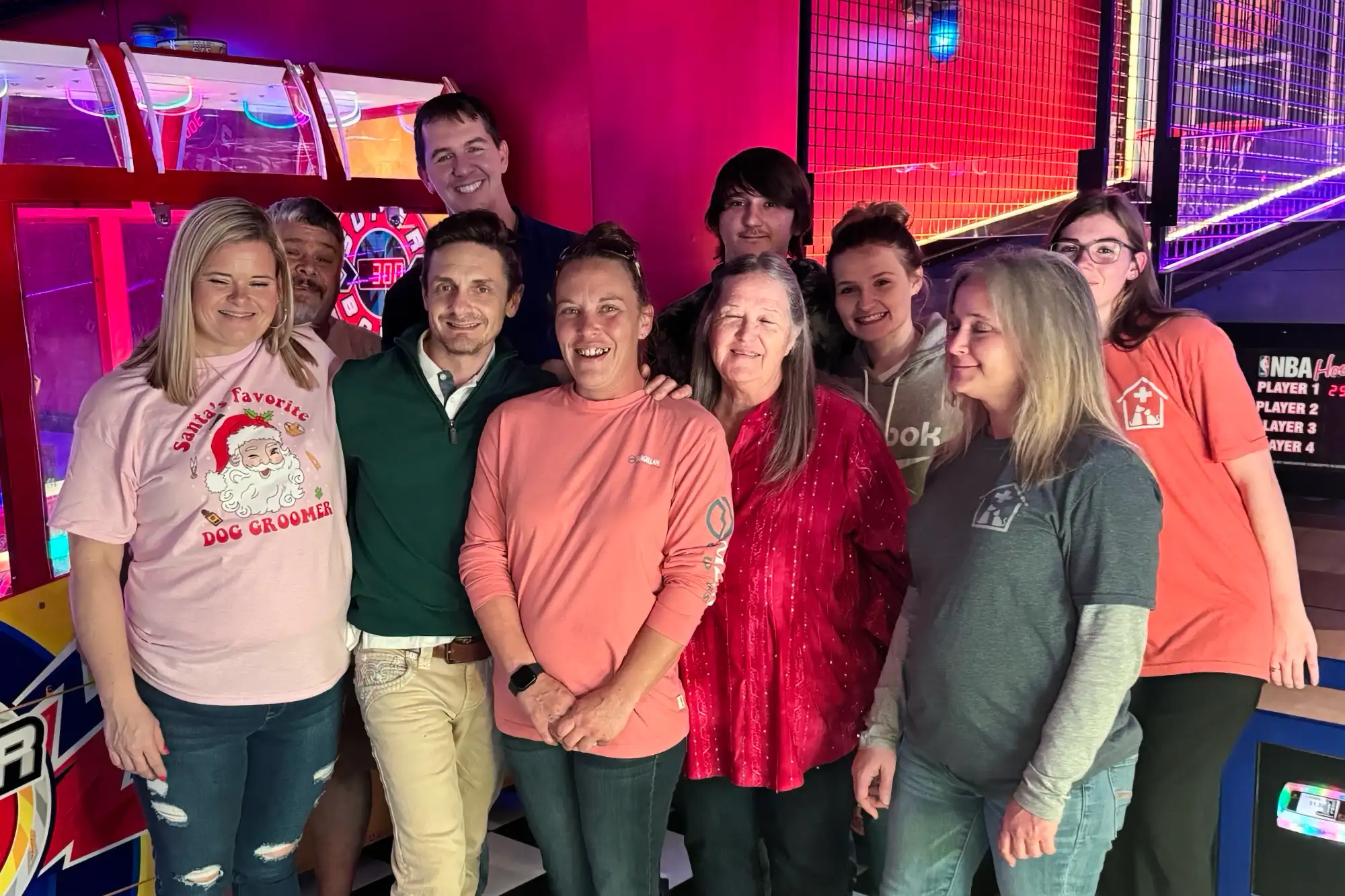 Dr Walker and staff at an arcade.