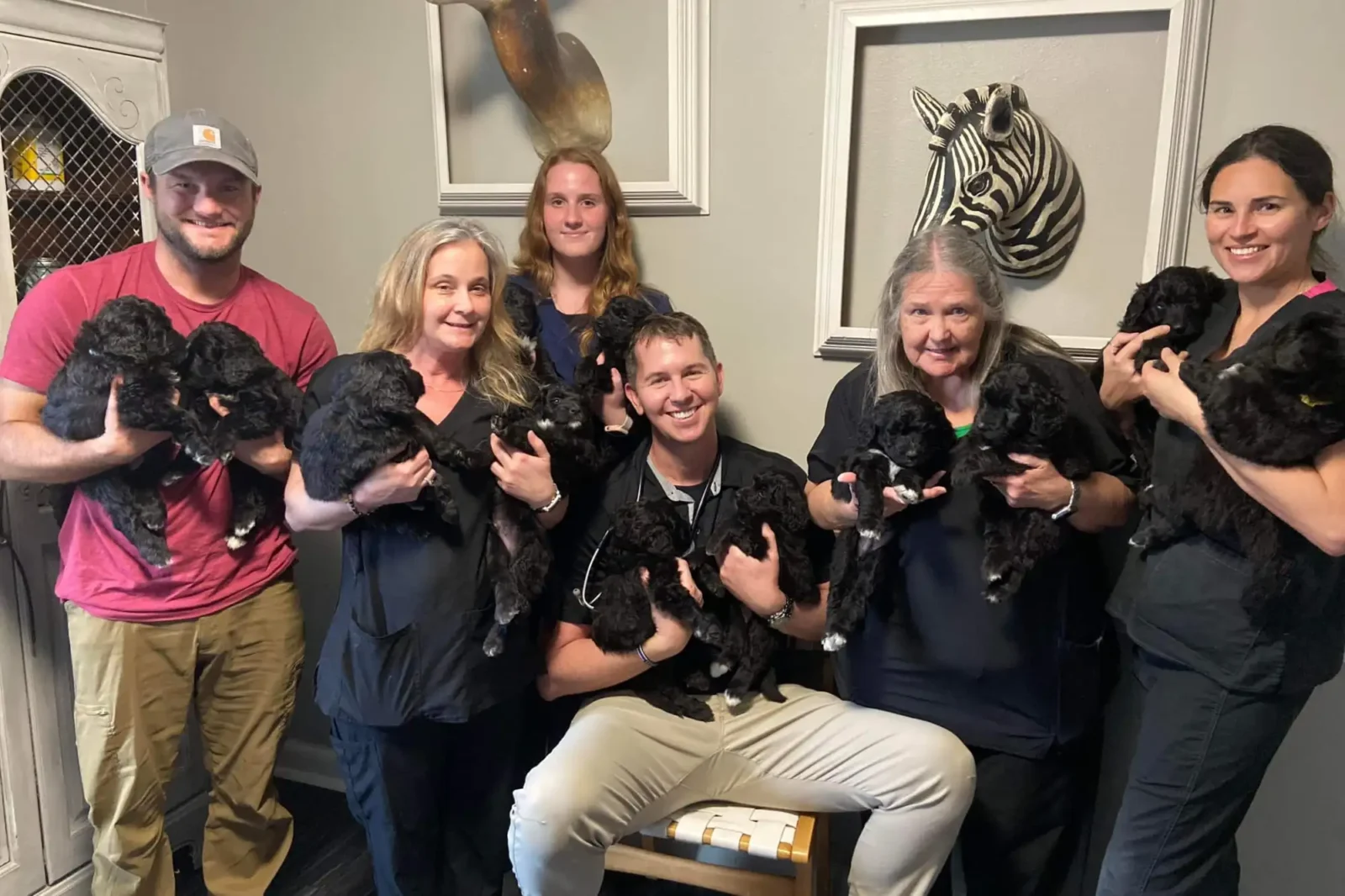 Walker team holding litter of puppies.
